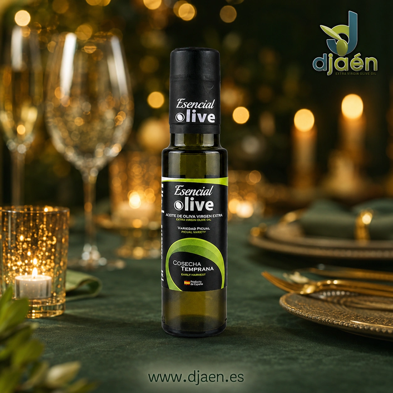 Botella de Esencial Olive Picual Temprano de 100 ml en una mesa con copas y velas.
